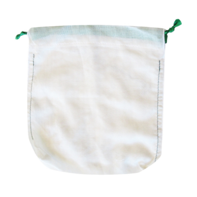White drawstring a cloth bag with a green ties.